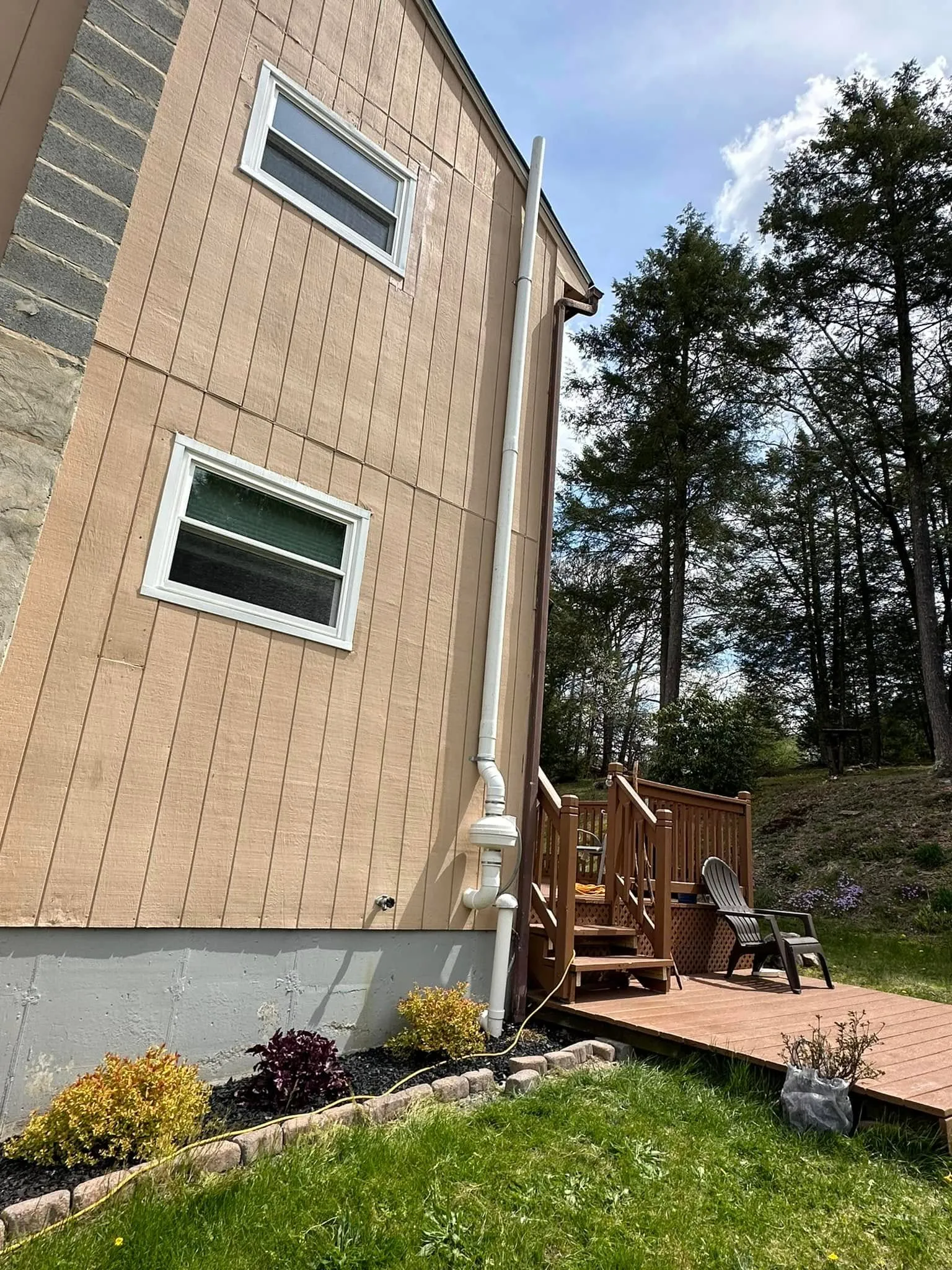 Exterior radon mitigation pipe installed on a York County home